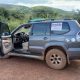 Toyota Land Cruiser 4x4 rental vehicle tracking an elephant herd during a self-drive safari to Akagera National Park Rwanda.