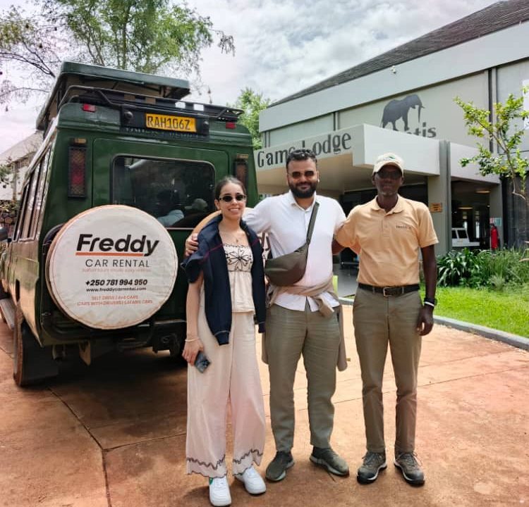 A professional safari guide standing next to a 4x4 Toyota Land Cruiser Prado on a scenic road, showcasing premium rent car with a driver Rwanda services.