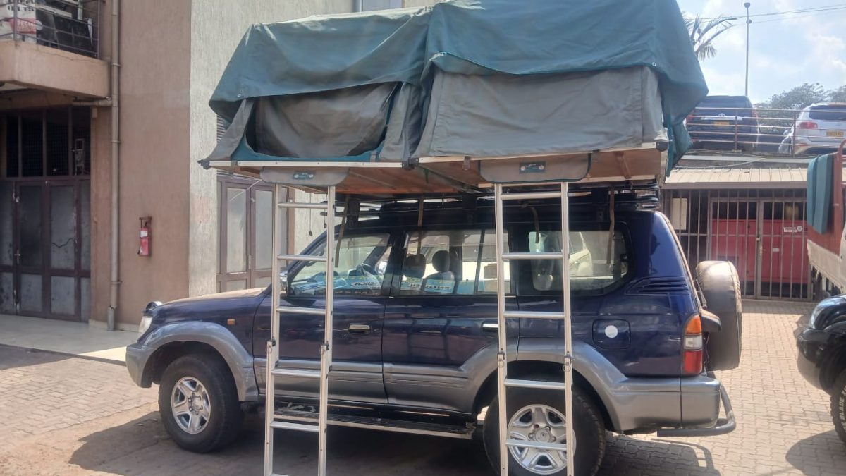 4x4 Toyota Land Cruiser safari vehicle equipped for Rooftop Tent Car Hire Rwanda driving on a dirt road in Akagera National Park.
