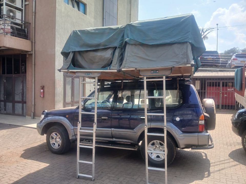 4x4 Toyota Land Cruiser safari vehicle equipped for Rooftop Tent Car Hire Rwanda driving on a dirt road in Akagera National Park.
